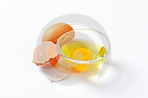 Egg white and yolk in glass bowl