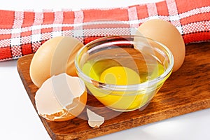 Egg white and yolk in glass bowl