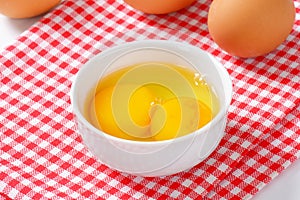 Egg whites and yolks in bowl photo