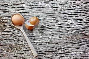 egg with wood spoon on retro wood table background