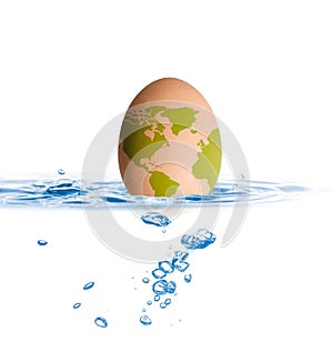 Egg with world map drop in blue water