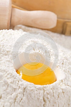 Egg yolk in flour, rolling pin ang sieve