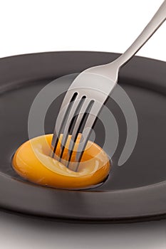 Egg yolk with fork pricking photo