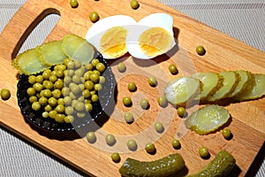 Egg yolk, pickled gherkins and canned green peas for cooking din