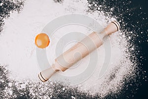 Egg yolk and rolling pin on flour