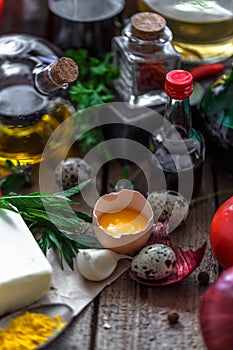 Egg yolk with various cooking ingredient in background