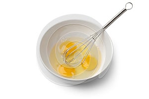 Egg yolks in a bowl with whisk photo