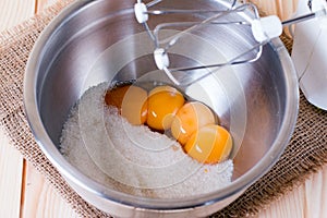 Egg yolks and sugar in a glass bowl