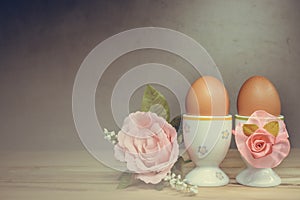 Eggcup and boiled egg, on wooden table.