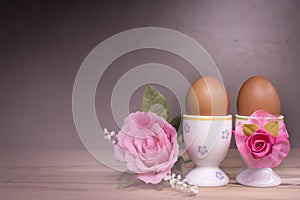 Eggcup and boiled egg, on wooden table.
