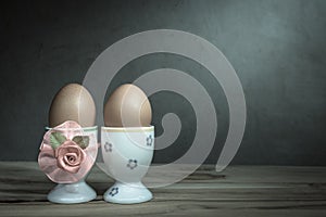 Eggcup and boiled egg, on wooden table.