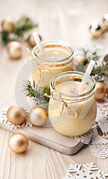 Eggnog alcoholic beverage served with cinnamon or nutmeg. Traditional drink often served during Christmas
