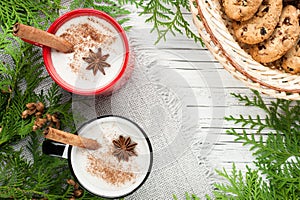 Eggnog cocktail in mug arranged with christmas decoration and co