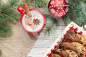 Eggnog cocktail in mug arranged with christmas decoration and co