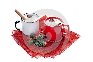 eggnog cocktail in mugs arranged with christmas decoration isolated on white background
