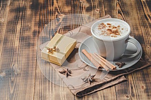 Eggnog. Traditional christmas cocktail, cinnamon sticks on a napkin. Wooden background