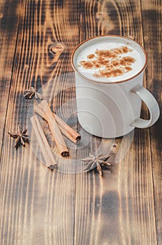 Eggnog. Traditional christmas cocktail and cinnamon sticks on wooden table. Copyspace