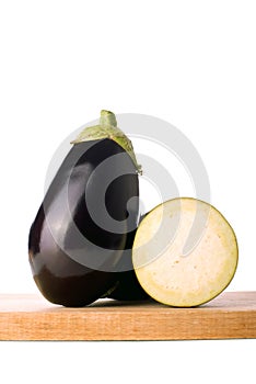 Eggplant or Aubergine on wooden chop board