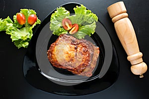 Eggplant Parmigiana with cherry tomato served in a dish isolated on dark background top view of italian food