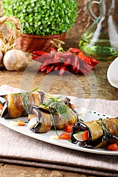 Eggplant rolls with cheese, tomato and basil