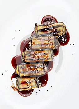 Eggplant rolls with eel. Isolated on a white background