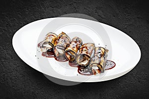 Eggplant rolls with eel. Isolated on a white background