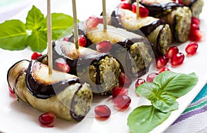 Eggplant rolls with nuts. Delicious starter of fried aubergines with nuts, herbs and pomegranate seeds