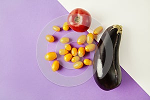 Eggplant, yellow red tomato ingredients isolated on colored background. Seasonal vegetables in modern style