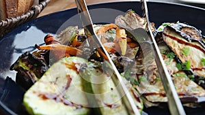 Eggplant zucchini carrots Grilled vegetables on a black plate, tasty and appetizing presentation