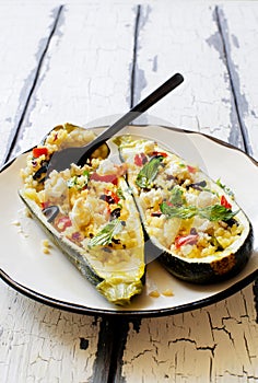 Eggplants stuffed with couscous , soft cheese and olives on white plate close up