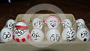 Eggs as characters including Where is Waldo are sitting in an egg carton