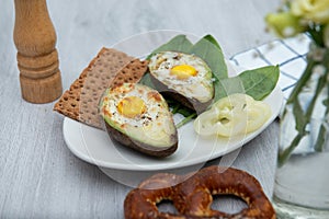 Eggs baked in avocado on plate