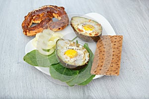 Eggs baked in avocado on plate