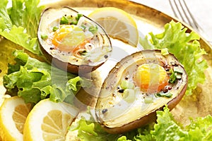 Eggs baked in avocado on plate, closeup