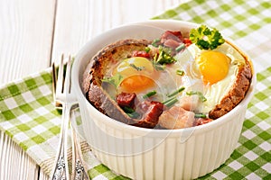 Eggs baked with bacon, tomatoes, garlic and bread.