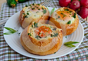 Eggs baked in a bun with ham, cheese and herbs.