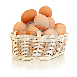 Eggs in basket isolated on white