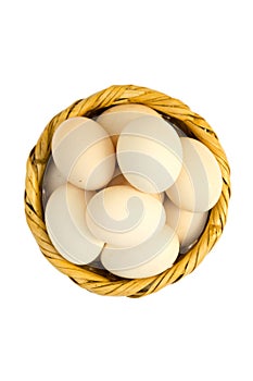 Eggs in a basket of reeds isolated