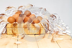 Eggs in basket on wooden with white background