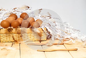 Eggs in basket on wooden with white background