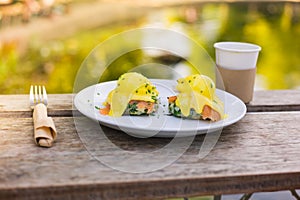 Eggs benedict on a plate in the park