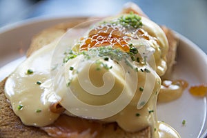 Eggs Benedict Royal, with smoked Salmon, poached eggs, Hollandaise sauce, Caviar and scallion