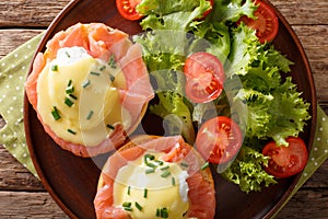 Eggs Benedict with salmon and hollandaise sauce close-up. horizontal top view