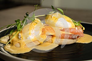 Eggs Benedict with salmon on a wooden table