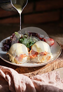 Eggs Benedict with smoked salmon, Hollandise sauce on bread