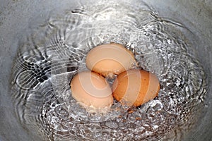 Eggs, Boiled egg in the pan, Raw Egg Reddish yellow in Hot water is boiling cooking Selective Focus