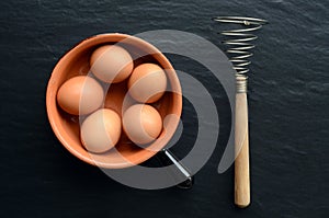 Eggs in a bowl with eggbeater