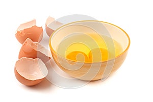 Eggs in bowl and eggshell on white