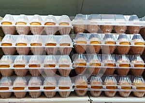 Eggs in a box with lots are sold on a shelf in a supermarket