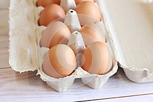 Eggs in a cardboard box. Fresh raw eggs in a paper egg container